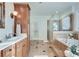 Bathroom with double sink vanity, sconces, shower and soaking tub at 3204 Woodrow Ne Way, Atlanta, GA 30319