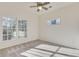Bright bedroom features neutral carpet, a ceiling fan, and natural light from two windows at 3204 Woodrow Ne Way, Atlanta, GA 30319