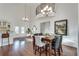 Dining room with modern chandelier, hardwood floors, and decorative painting at 3204 Woodrow Ne Way, Atlanta, GA 30319
