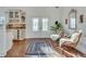 Welcoming foyer with bright windows, a modern rug, and a view of the kitchen at 3204 Woodrow Ne Way, Atlanta, GA 30319