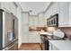 Eat-in kitchen featuring stainless steel refrigerator, built in microwave, and white cabinetry at 3204 Woodrow Ne Way, Atlanta, GA 30319