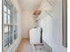 Laundry room features tiled floor, shelving, utility sink, and a window with natural light at 3204 Woodrow Ne Way, Atlanta, GA 30319