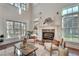 Living room with high ceilings, large windows, fireplace, and hardwood floors at 3204 Woodrow Ne Way, Atlanta, GA 30319