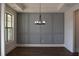 Dining area features decorative paneling with a modern chandelier and abundant natural light at 3709 Tielman St, Snellville, GA 30078