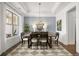 Spacious dining room showcasing an elegant chandelier and natural light from large windows at 3709 Tielman St, Snellville, GA 30078