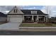 Charming, single-story home featuring a two-car garage and welcoming front porch with stone accents at 3709 Tielman St, Snellville, GA 30078