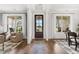 Bright foyer featuring wood floors, elegant lighting, and views of the living and dining areas at 3709 Tielman St, Snellville, GA 30078