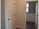 Hallway featuring hardwood floors, decorative doors, and a view to the dining room at 3709 Tielman St, Snellville, GA 30078
