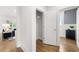 Hallway featuring hardwood floors, an open closet, and views into the living and dining room at 3709 Tielman St, Snellville, GA 30078