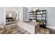 Home office with neutral decor features a large desk and built-in bookshelves at 3709 Tielman St, Snellville, GA 30078