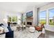 Cozy living room featuring fireplace, large windows, and comfortable seating area at 3709 Tielman St, Snellville, GA 30078