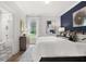 Bright main bedroom with large bed, ensuite bathroom and wooden dresser under large window overlooking yard at 3709 Tielman St, Snellville, GA 30078