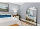 Well-lit main bedroom with modern furnishings and a large mirror at 3709 Tielman St, Snellville, GA 30078