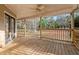 Wooden back porch with ceiling fan and backyard view at 1489 New Hope Rd, Locust Grove, GA 30248