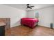 Spacious bedroom with hardwood floors and a ceiling fan at 1489 New Hope Rd, Locust Grove, GA 30248