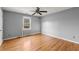 Bedroom with hardwood floors and a ceiling fan at 1489 New Hope Rd, Locust Grove, GA 30248