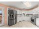 Galley kitchen with stainless steel appliances and white cabinets at 1489 New Hope Rd, Locust Grove, GA 30248