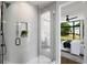 Modern bathroom with a glass shower, tile walls, and a view into the bedroom at 105 Georgia Se Ave # 5, Atlanta, GA 30312