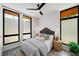 Cozy bedroom with neutral tones, large windows with privacy film, and modern ceiling fan at 105 Georgia Se Ave # 5, Atlanta, GA 30312