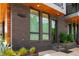 Close-up of unit exterior with brick facade, wood accents, and modern windows, set amidst lush landscaping at 105 Georgia Se Ave # 5, Atlanta, GA 30312