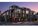 Contemporary townhome building with modern design, large windows, and private balconies at dusk at 105 Georgia Se Ave # 5, Atlanta, GA 30312