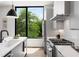 Bright kitchen with stainless steel appliances, white cabinets, and a large window overlooking lush greenery at 105 Georgia Se Ave # 5, Atlanta, GA 30312