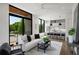Open-concept living room with floor-to-ceiling windows and a modern kitchen, offering stunning views and ample light at 105 Georgia Se Ave # 5, Atlanta, GA 30312