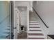 Bright staircase with white risers, wood treads, and sleek black railing, leading to the upper level at 105 Georgia Se Ave # 5, Atlanta, GA 30312