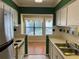 Kitchen with white cabinets and view into sunroom at 2704 Huntingdon, Atlanta, GA 30350