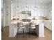 Well-lit kitchen featuring stainless steel appliances, an island with seating, and ample cabinet space at 7170 Pond View Dr, Cumming, GA 30028
