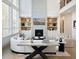 Bright, modern living room with high ceilings, fireplace and large windows overlooking wooded area at 7170 Pond View Dr, Cumming, GA 30028