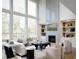 Bright living room boasting soaring windows, a fireplace, and built-in shelving at 7170 Pond View Dr, Cumming, GA 30028