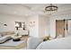 Bright main bedroom with a sitting area, a sliding barn door, and a modern chandelier at 7170 Pond View Dr, Cumming, GA 30028
