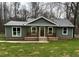 Newly constructed home with gray siding, front porch, and landscaped lawn at 10033 Florence Cir, Villa Rica, GA 30180