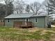 Gray house with wooden deck, surrounded by a yard with brown grass at 10033 Florence Cir, Villa Rica, GA 30180