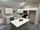 Modern kitchen with white cabinets, quartz countertops, and an island at 10033 Florence Cir, Villa Rica, GA 30180