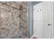 Modern shower with marble-style tile and glass enclosure at 145 Turning Pt, Stockbridge, GA 30281