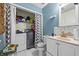 Bathroom with combined laundry, white vanity, and shower at 145 Turning Pt, Stockbridge, GA 30281