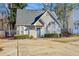 Tan house with gray roof, landscaping, and a small driveway at 145 Turning Pt, Stockbridge, GA 30281