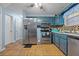 Kitchen with stainless steel appliances and blue cabinets at 145 Turning Pt, Stockbridge, GA 30281