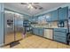 Kitchen with teal cabinets and stainless steel appliances at 145 Turning Pt, Stockbridge, GA 30281