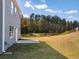 Side view of house showcasing gray siding, patio, and grassy yard at 37 Willow Green Trce, Dallas, GA 30157