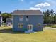 Rear view of two-story house, gray siding, and patio at 37 Willow Green Trce, Dallas, GA 30157