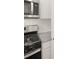 Stainless steel range and microwave in a kitchen with white cabinets at 37 Willow Green Trce, Dallas, GA 30157