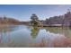 Calm pond view with tree reflections at 605 Spruce Dr, Pine Lake, GA 30072
