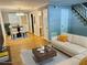 Virtually staged living room with off-white couch and a dining area at 1683 Briarcliff Ne Rd # 4, Atlanta, GA 30306
