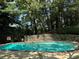Community swimming pool surrounded by trees and stone wall at 1683 Briarcliff Ne Rd # 4, Atlanta, GA 30306
