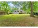 Large backyard with a view of the house and trees at 2253 Bonnybrook Sw Way, Atlanta, GA 30311