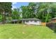 Newly renovated ranch home with white brick exterior, situated on a large lot with mature trees at 2253 Bonnybrook Sw Way, Atlanta, GA 30311