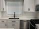 Modern kitchen featuring white shaker cabinets, quartz countertops, and stainless steel appliances at 2253 Bonnybrook Sw Way, Atlanta, GA 30311